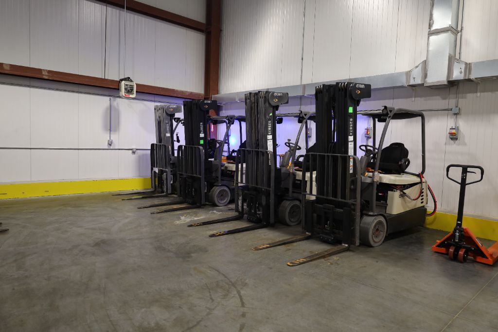 Crown electric forklifts lined up inside Mid Eastern Cold Storage facility
