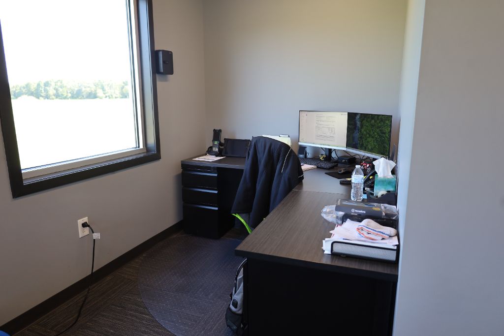 Mid Eastern Cold Storage office workspace with dual monitors and a view of the grounds